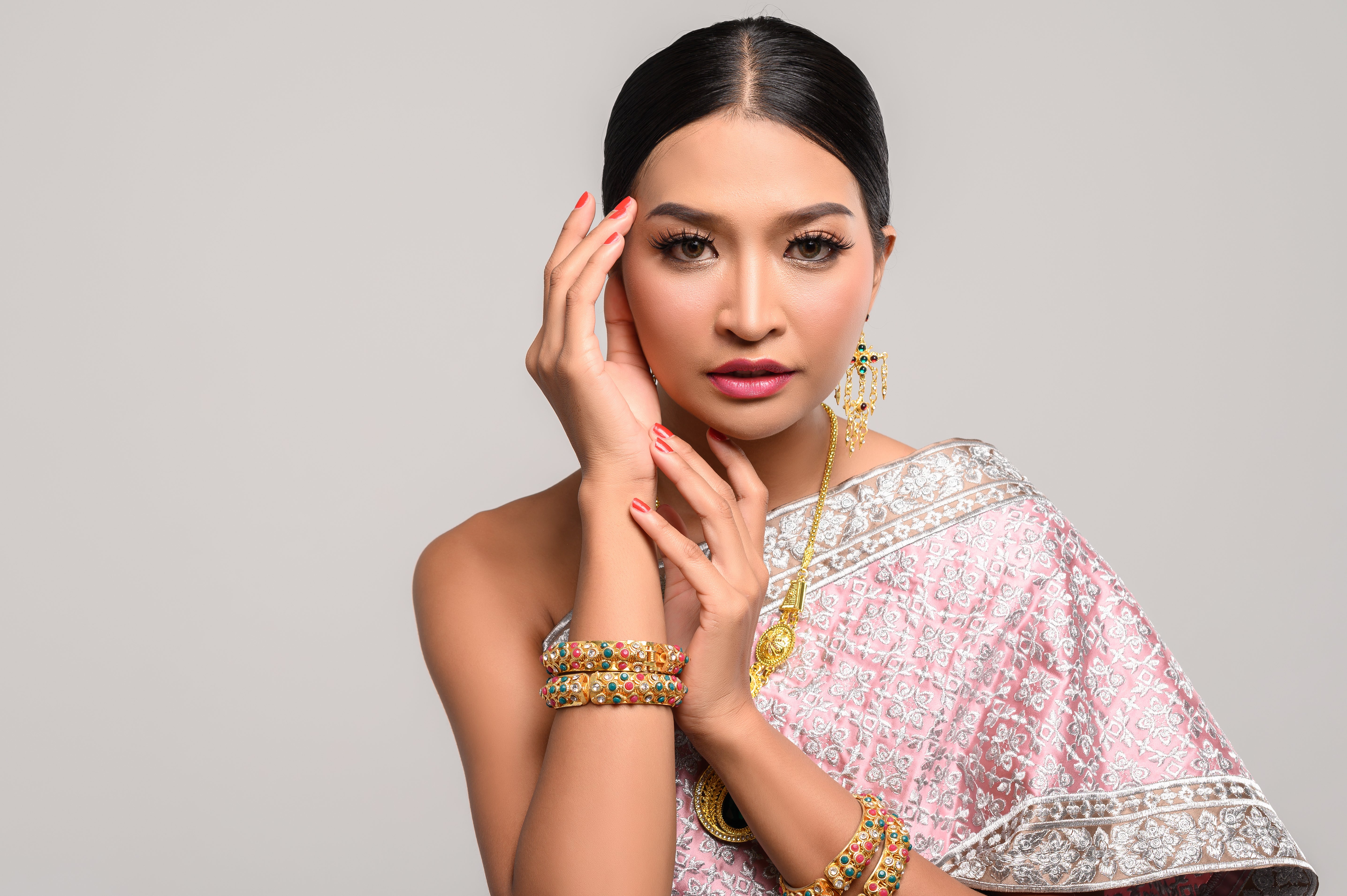 woman wearing thai clothes hands touching head